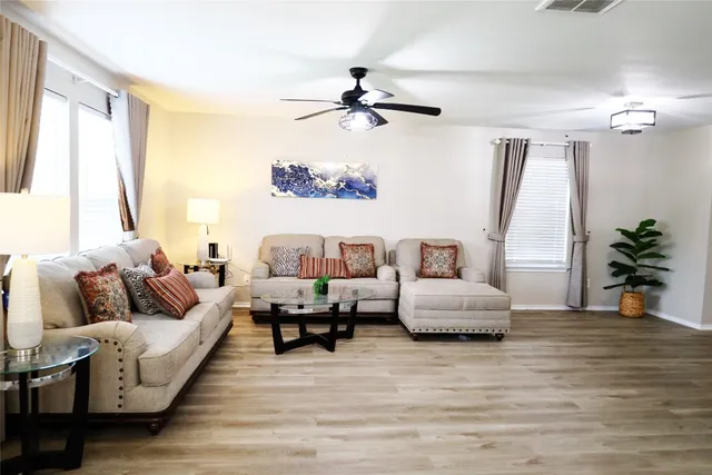 a living room with furniture and a large window