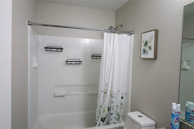 a bathroom with a shower and a toilet