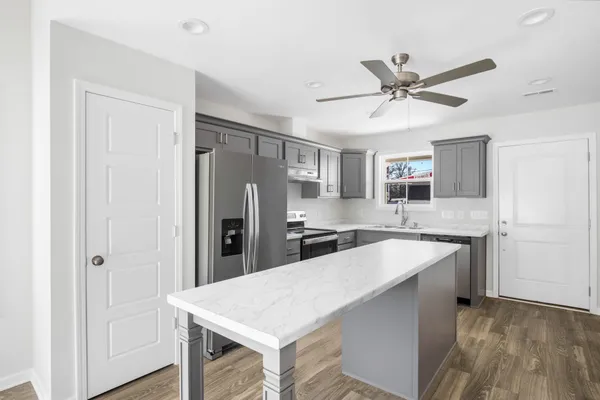 a kitchen with stainless steel appliances a refrigerator sink and stove