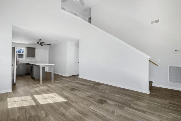 a view of a kitchen with wooden floor and a kitchen