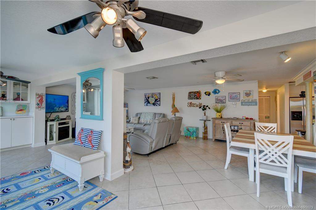 3541 Northeast Ocean Boulevard, Unit 19 Stuart, FL 34996 - Photo 11 of 52 a living room with furniture and a chandelier