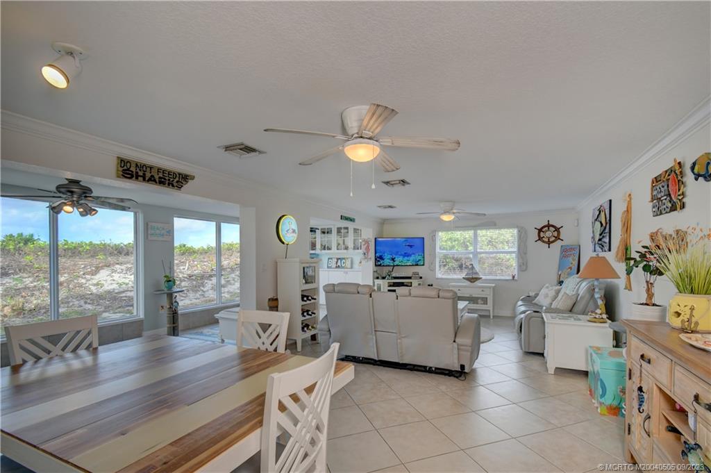 3541 Northeast Ocean Boulevard, Unit 19 Stuart, FL 34996 - Photo 12 of 52 a living room with furniture and kitchen view