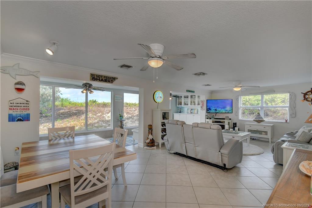 3541 Northeast Ocean Boulevard, Unit 19 Stuart, FL 34996 - Photo 13 of 52 a living room with furniture and a large window