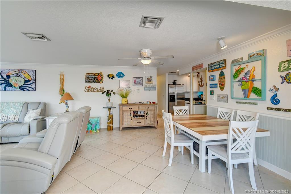 3541 Northeast Ocean Boulevard, Unit 19 Stuart, FL 34996 - Photo 14 of 52 a dining room with furniture and window
