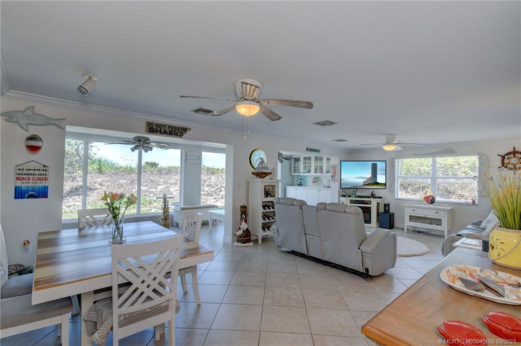 3541 Northeast Ocean Boulevard, Unit 19 Stuart, FL 34996 - Photo 16 of 52 a living room with furniture and large windows