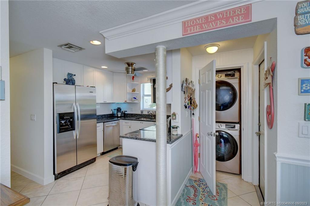 3541 Northeast Ocean Boulevard, Unit 19 Stuart, FL 34996 - Photo 18 of 52 a kitchen with a refrigerator and washer