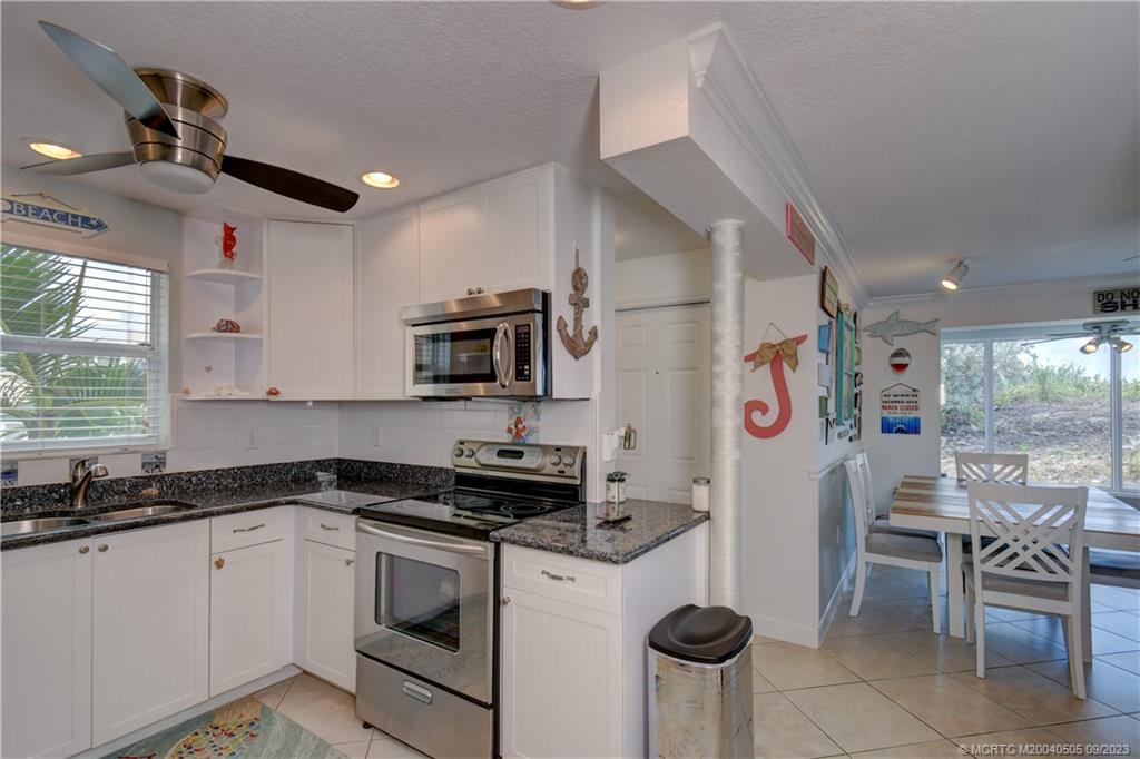 3541 Northeast Ocean Boulevard, Unit 19 Stuart, FL 34996 - Photo 19 of 52 a kitchen that has a lot of cabinets in it and appliances