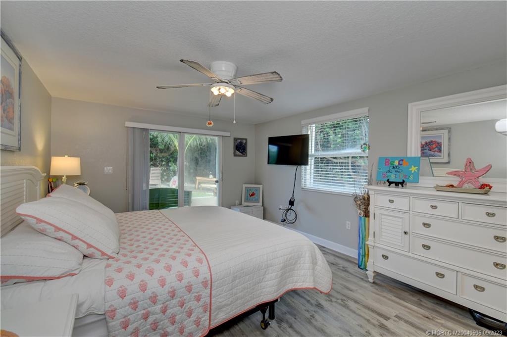 3541 Northeast Ocean Boulevard, Unit 19 Stuart, FL 34996 - Photo 20 of 52 a bedroom with a large bed and a window