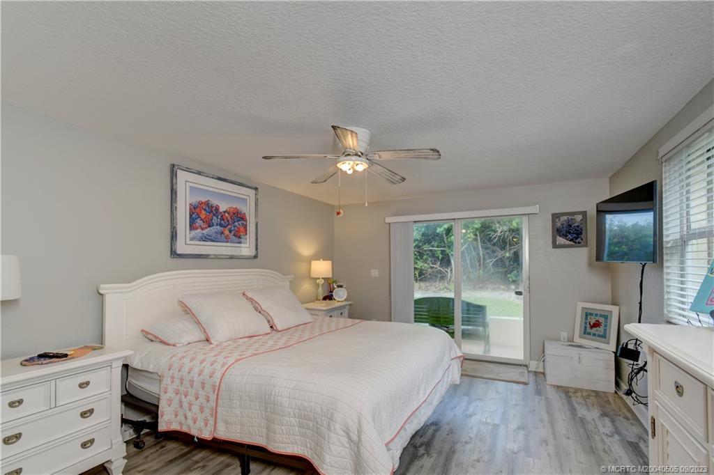 3541 Northeast Ocean Boulevard, Unit 19 Stuart, FL 34996 - Photo 21 of 52 a bedroom with a large bed and a window