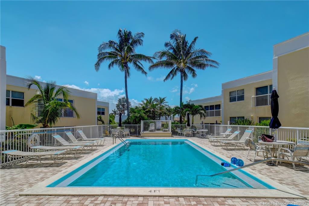 3541 Northeast Ocean Boulevard, Unit 19 Stuart, FL 34996 - Photo 39 of 52 a swimming pool with outdoor seating