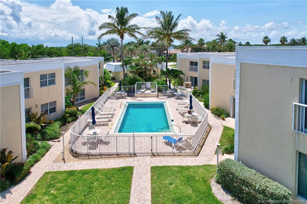 3541 Northeast Ocean Boulevard, Unit 19 Stuart, FL 34996 - Photo 45 of 52 a view of an house with backyard outdoor seating and green space