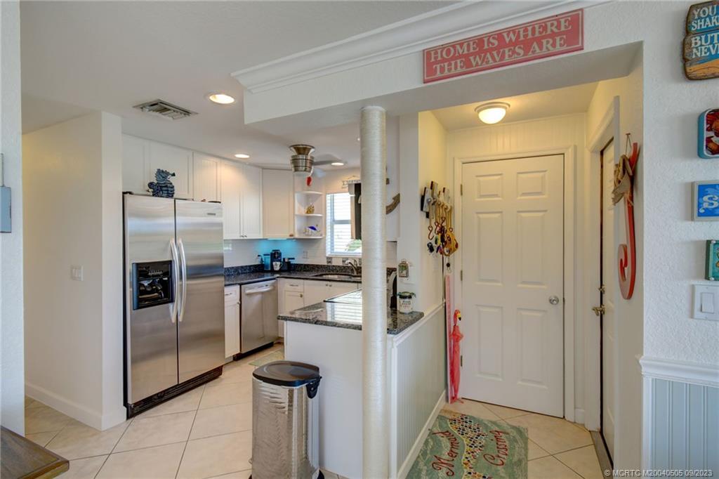3541 Northeast Ocean Boulevard, Unit 19 Stuart, FL 34996 - Photo 5 of 52 a kitchen with stainless steel appliances granite countertop a refrigerator and a sink