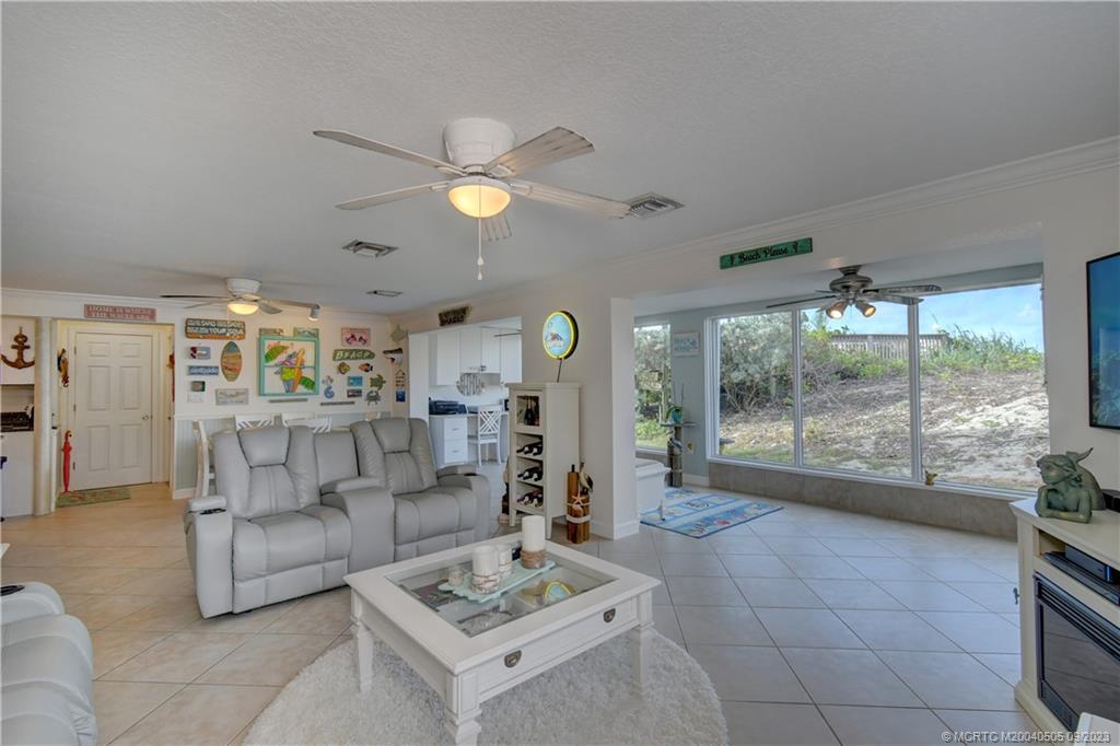 3541 Northeast Ocean Boulevard, Unit 19 Stuart, FL 34996 - Photo 7 of 52 a living room with furniture and a large window
