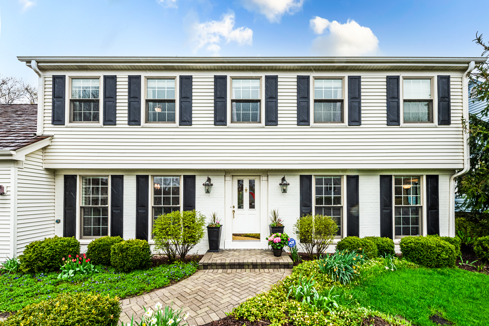 117 Whitney Drive Barrington, IL 60010 - Photo 2 of 37 a front view of a house with garden and porch