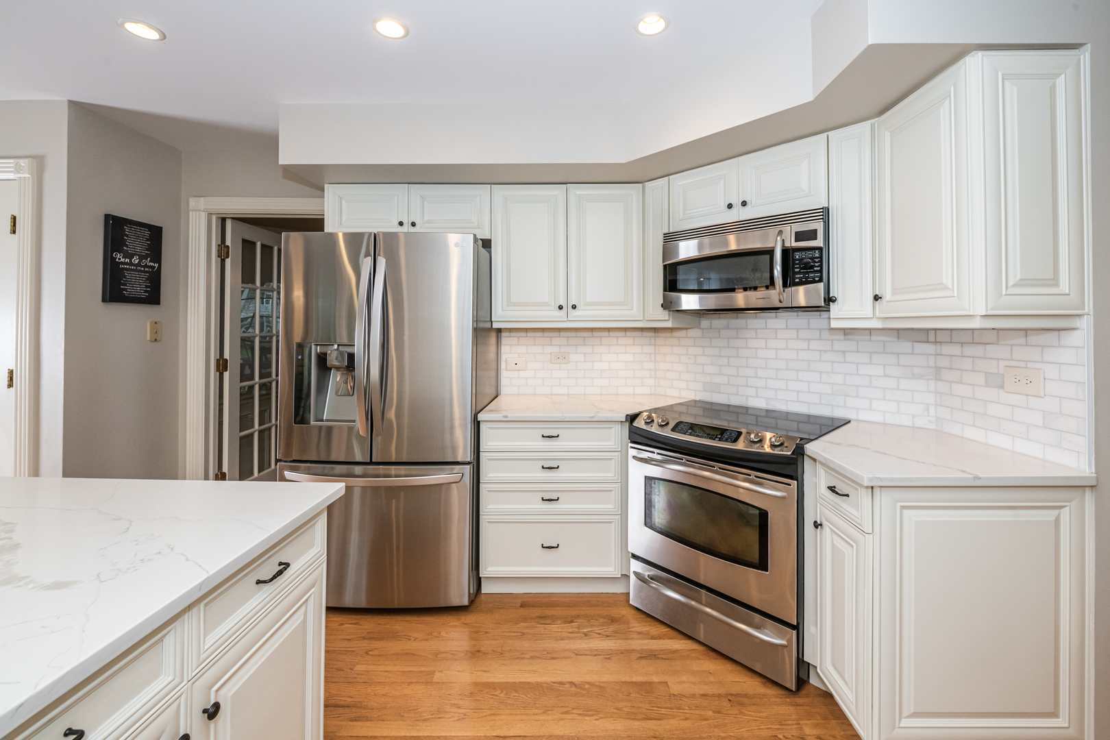 117 Whitney Drive Barrington, IL 60010 - Photo 7 of 37 a kitchen with granite countertop a refrigerator stove and microwave