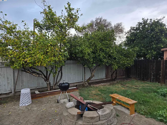 a view of a backyard with sitting area