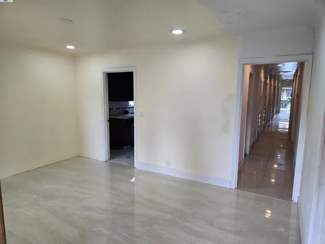 a view of an empty room with bathroom