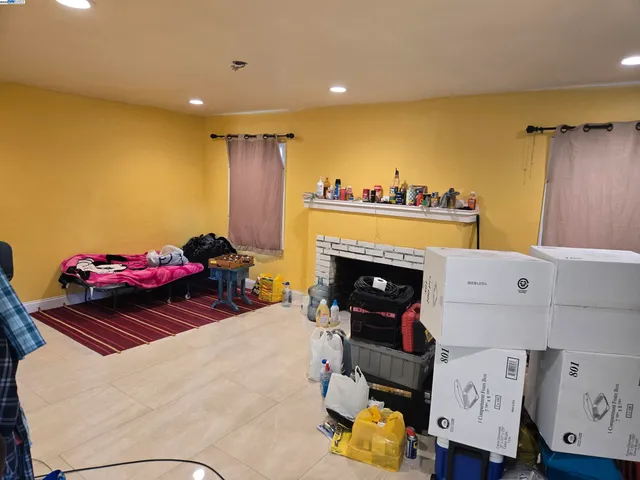 a bedroom with a bed and a fireplace