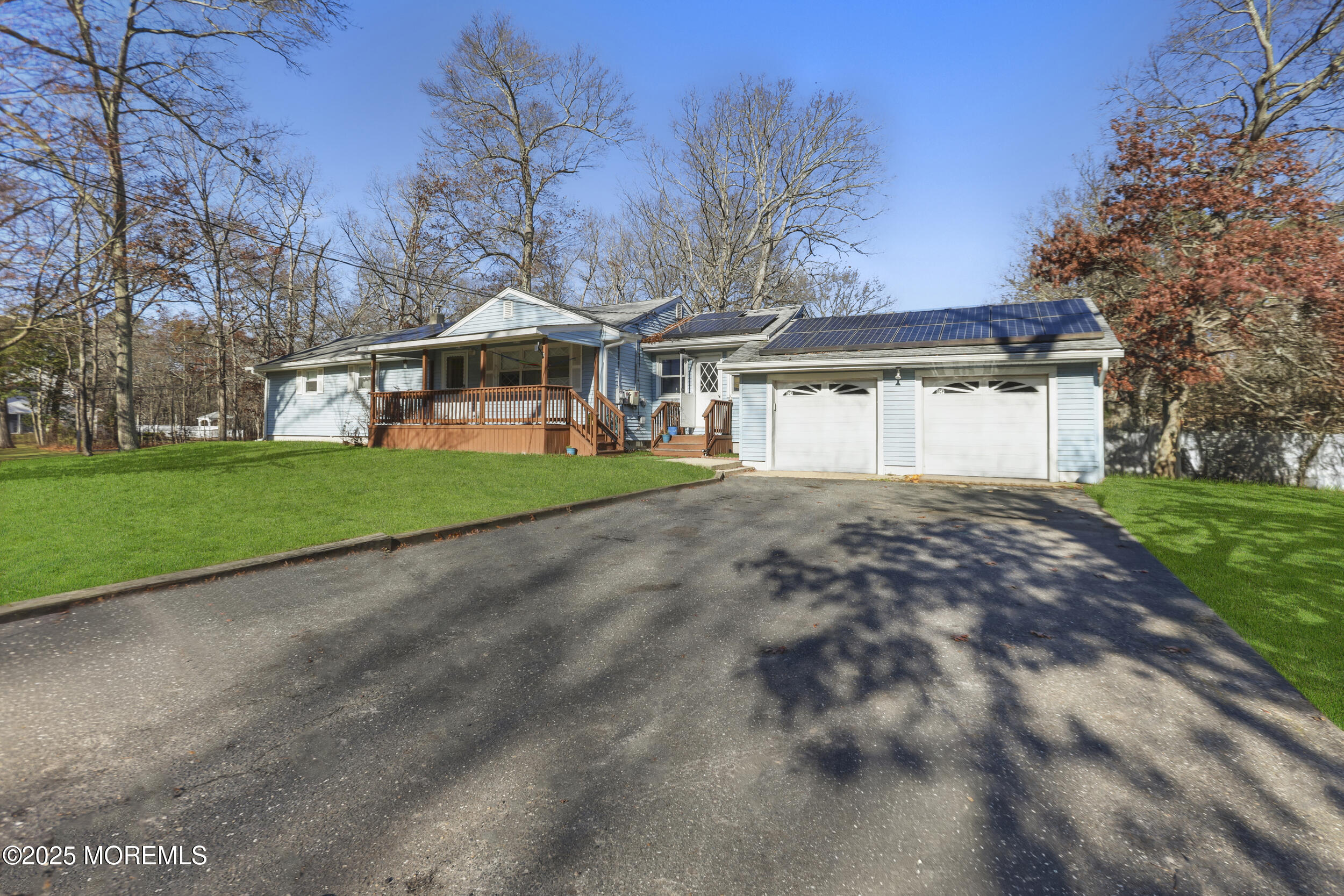 58 East Pleasant Grove Road Jackson, NJ 08527 - Photo 3 of 8 a front view of a house with a garden and trees