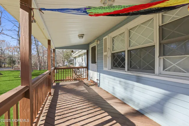 a balcony with wooden floor and glass door