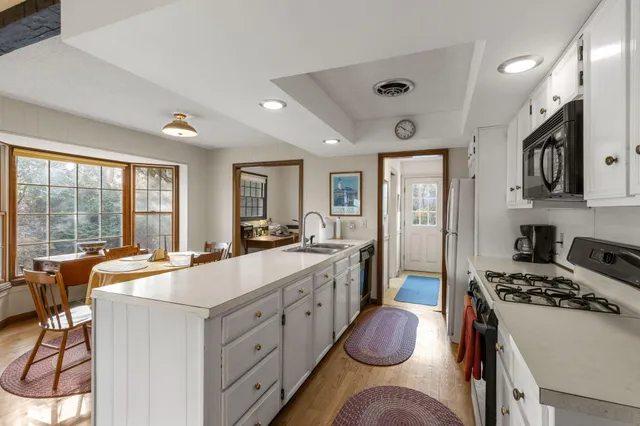 a view of a workspace with wooden floor