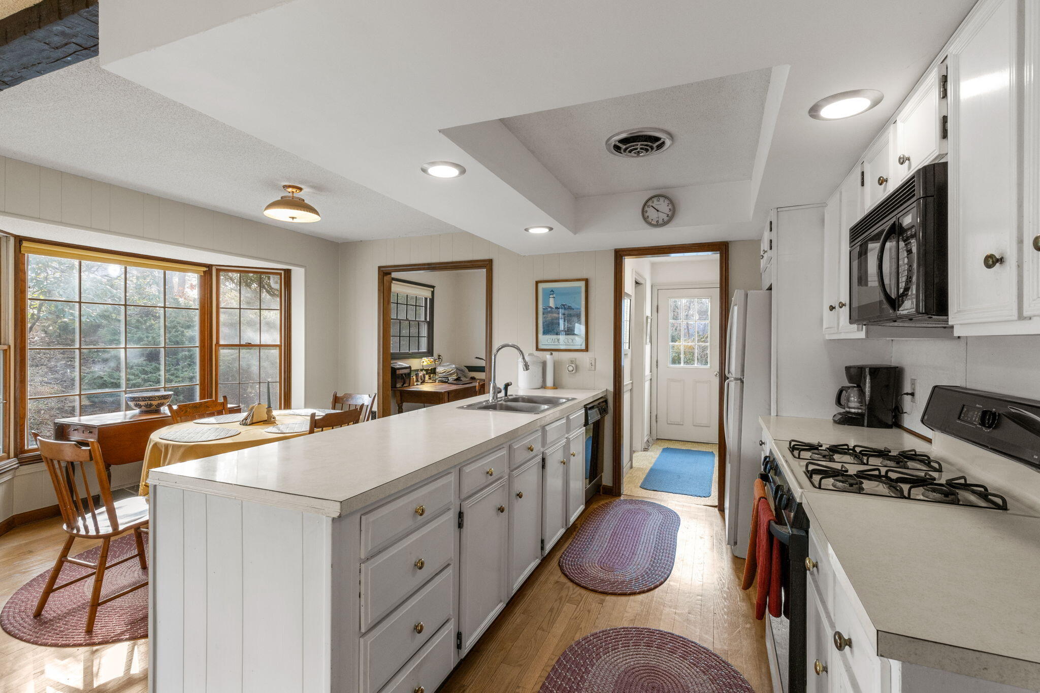 46 Chippingstone Road Chatham, MA 02633 - Photo 11 of 35 a large kitchen with kitchen island a stove a sink and a refrigerator