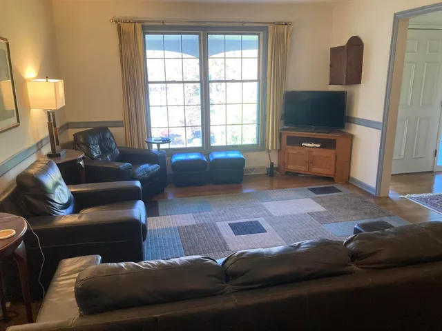 a living room with furniture and a rug