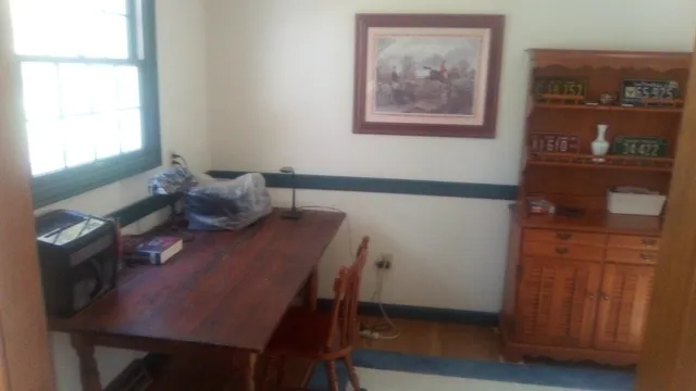 a bedroom with a bed window and a night stand