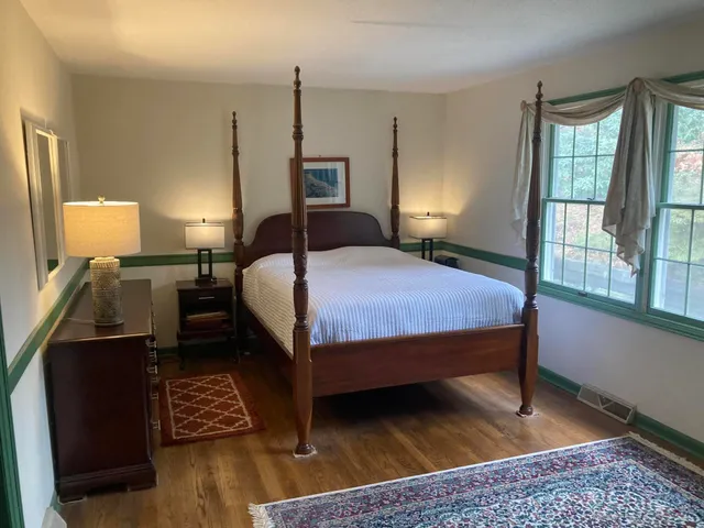 a bedroom with a bed a window and walk in closet