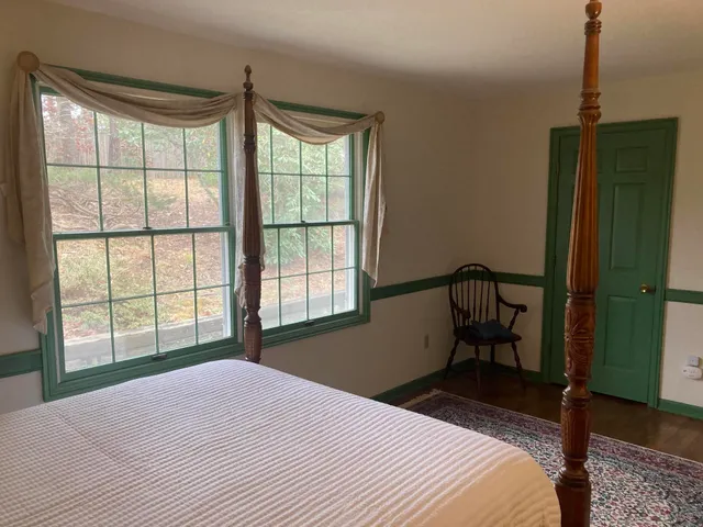 a bedroom with bed and a window
