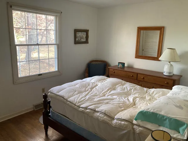 a bedroom with a bed and a lamp on table