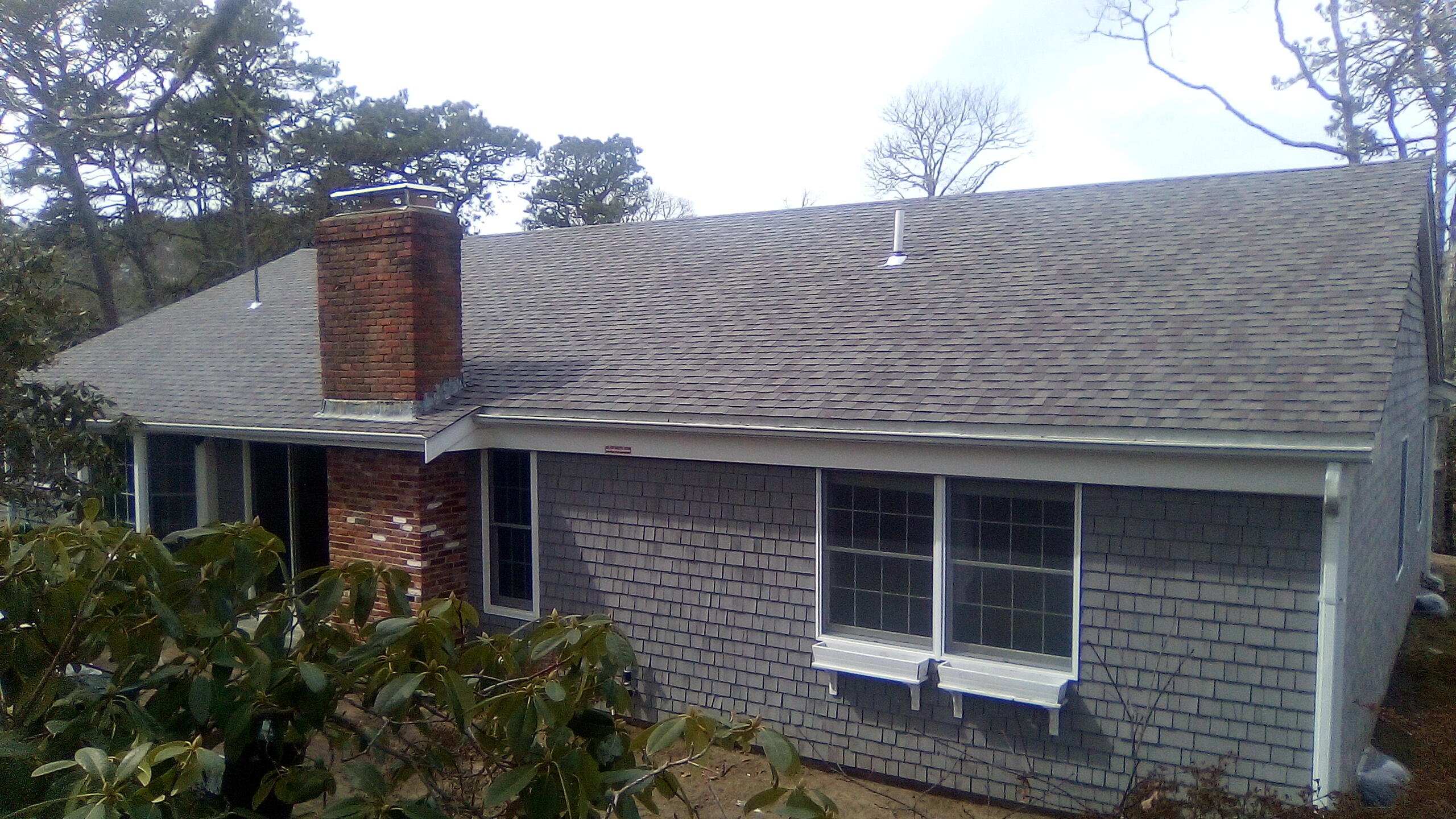46 Chippingstone Road Chatham, MA 02633 - Photo 32 of 35 a front view of a house with a yard and garage