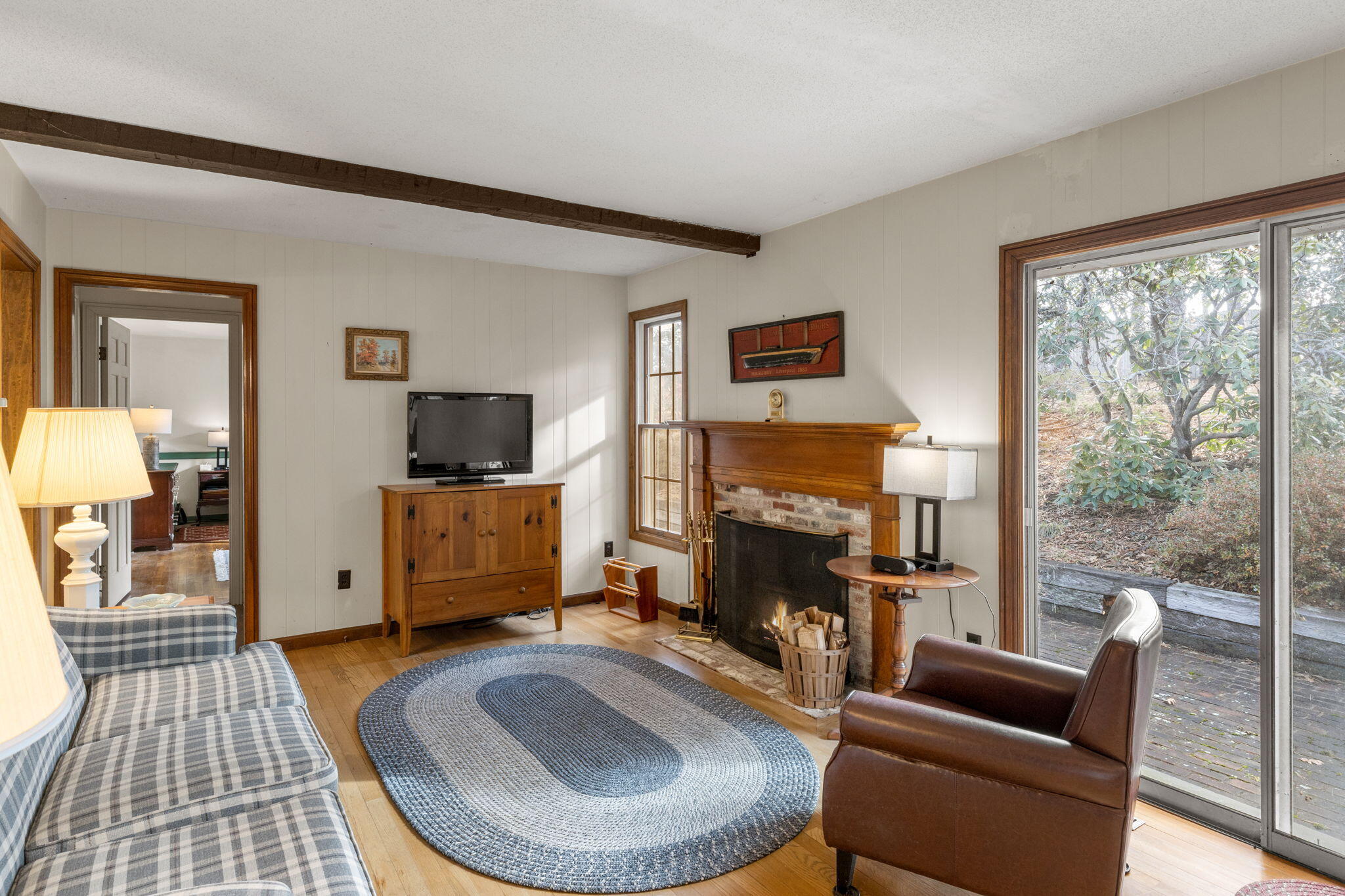 46 Chippingstone Road Chatham, MA 02633 - Photo 10 of 35 a living room with furniture a flat screen tv and a fireplace