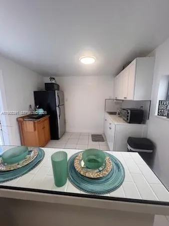 a kitchen with a refrigerator and a stove