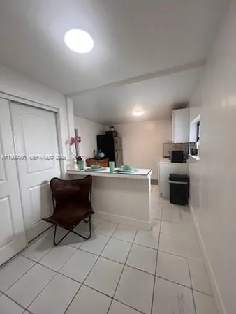 a kitchen with a sink and white cabinets