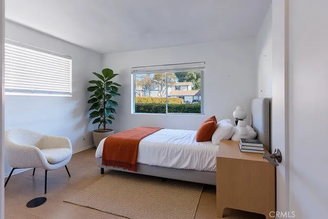 a bedroom with a bed and a painting on the wall