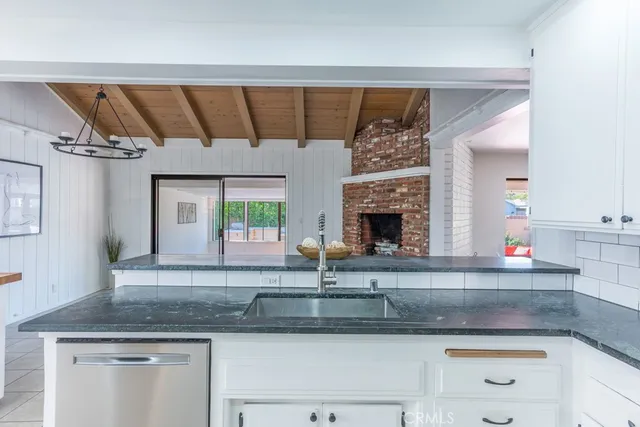 a kitchen with cabinets and chairs