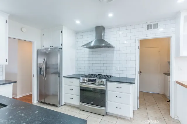 a large kitchen with lots of counter space and windows