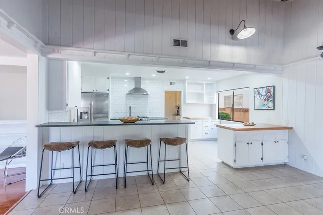 a view of hallway with bathroom and wooden floor