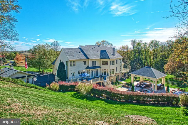 a view of a house with a yard and large tree
