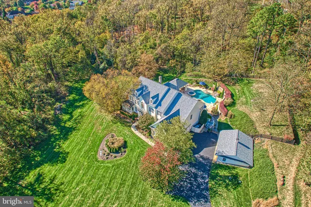 an aerial view of a house with a yard basket ball court and outdoor seating