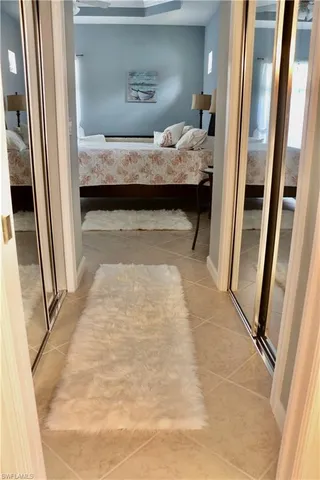 a bedroom with a bed and a mirror