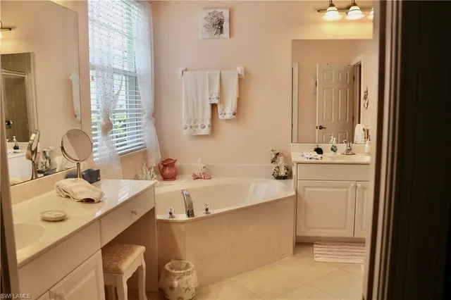 a bathroom with a bathtub sink and mirror
