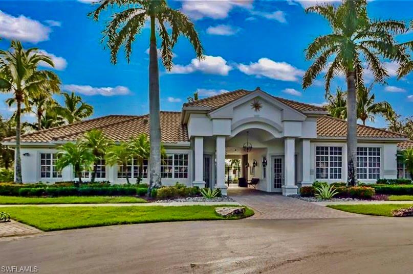 16192 Parque Lane Naples, FL 34110 - Photo 19 of 30 a view of a house with a yard and palm trees