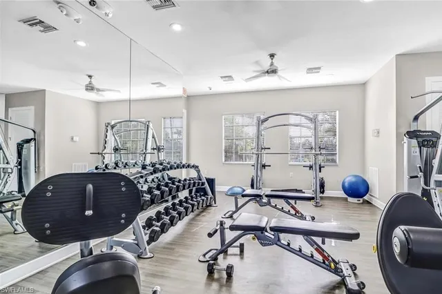 a room with lots of chairs and mirrors