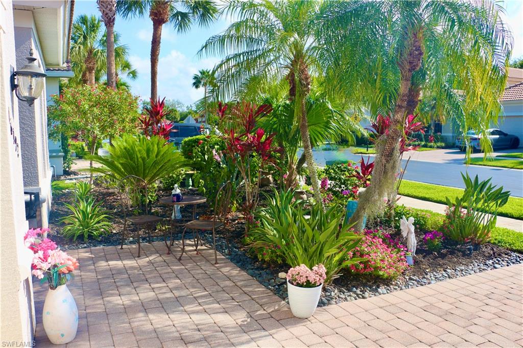 16192 Parque Lane Naples, FL 34110 - Photo 3 of 30 a backyard of a house with lots of green space and trees