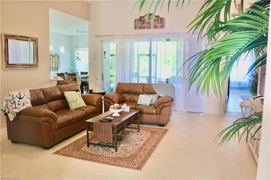 16192 Parque Lane Naples, FL 34110 - Photo 6 of 30 a living room with patio furniture and a potted plant