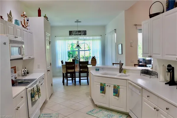 a kitchen with kitchen island a sink stove and cabinets