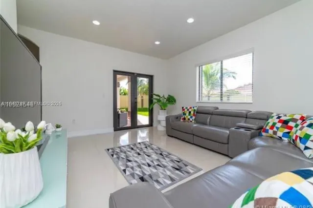 a living room with furniture and a potted plant