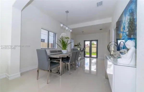 a dining room with furniture and window